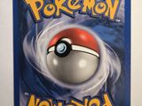 a close up of a pokemon card on a white surface