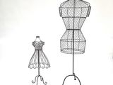 two wire mannequins and a dress form on a stand