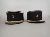 pair of black and gold hats with gold trims on them