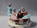 a figurine of three people riding in a sleigh