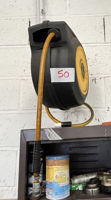 a black and yellow hose on top of a shelf