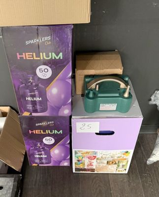 two boxes of helium on the floor next to a teddy bear