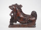 an image of a wooden sculpture of a horse with a man on it ' s back