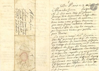 un vieux document comportant des inscriptions et sur lequel figure l'image d'une horloge au recto