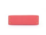 a pink purse with gold studs on the front