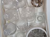 bottles and glasses in a wooden box on a white surface