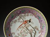 an image of a plate with a bird on it on a stand