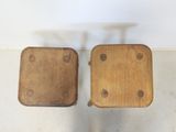two wooden stools sitting on top of a floor next to each other