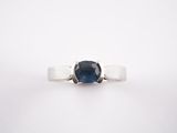 a close up of a blue sapphire ring on a white background