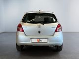 a silver car parked in a room with a white wall