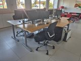 a desk with two computer monitors and a chair in the room
