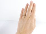 a woman ' s hand with a diamond ring on it