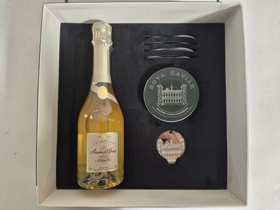 a picture of a bottle of wine and a comb in a box