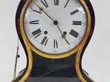 a black and gold clock with roman numerals on it
