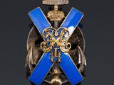 an image of a blue and gold broochle with a cross on it