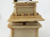 a small wooden box with a spool on top of it