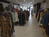 a lot of clothes that are on display in a store