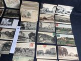 several old postcards of different types and sizes are on a table