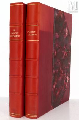 two red books sitting on top of each other on a white surface