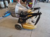 a machine that is sitting on the ground in the garage
