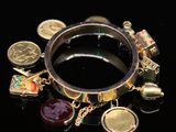 a ring with many charms on it on a black surface