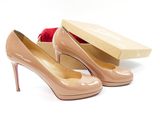 nude patent pumps with a box and rose on the side
