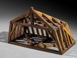 a small wooden structure with a roof made out of wood