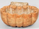 an image of a clay bowl with a piece of bread in it