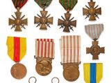an assortment of medals and medals are displayed on a white surface