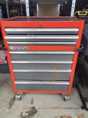 a close up of a red tool cabinet in a garage