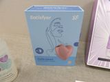 a box with a pink heart on it next to a bottle of sanitizer