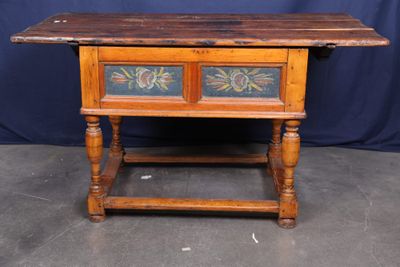 an old wooden table with two drawers on top of it