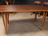 an image of a dining table with chairs around it