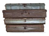 four suitcases stacked on top of each other on a white surface