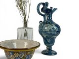 two vases and a bowl sitting next to each other