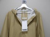 beige rain jacket with a tag on it hanging on a hanger