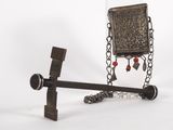 a metal object with a chain and a book on it