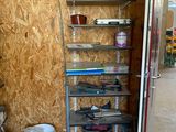 a room with shelves and buckets in the corner of the room