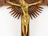 an antique wooden crucif with a cross and sunburst