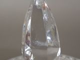 a clear glass object sitting on top of a glass plate