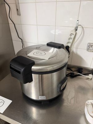 stainless steel counter top with an electric pressurer on top of it