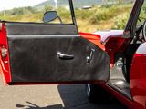 a red car with its door open on the street