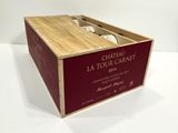 a wooden box with a bottle of wine inside of it