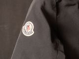 a close up of the back of a black jacket with a badge on it