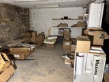 a room filled with boxes and a refrigerator in it