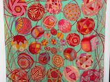 a colorful piece of art hanging on a wall