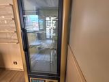 a refrigerator that is sitting in the corner of a room