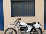 a motorcycle parked in front of a building with blue doors