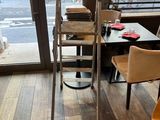 a ladder that is leaning against the wall in a restaurant