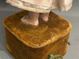 a doll that is standing on top of a box